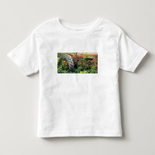 Spring flowers adorn an old tractor. toddler t-shirt