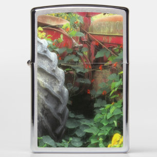 Spring flowers adorn an old tractor. zippo lighter