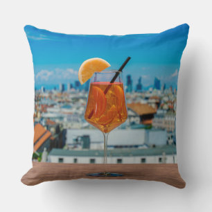 Spritz cocktail on a table with view of Milan Throw Pillow