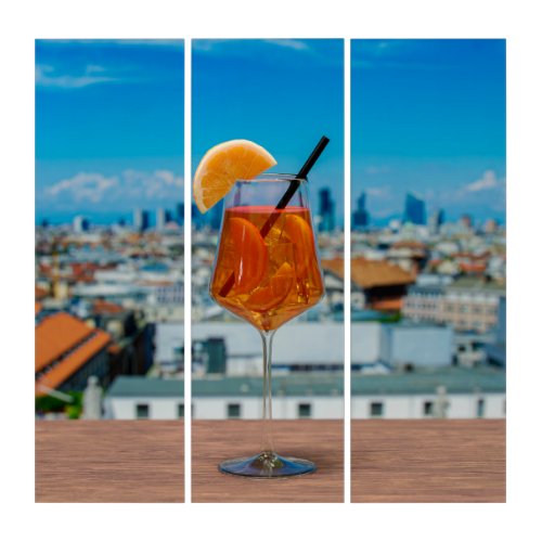 Spritz cocktail on a table with view of Milan Triptych