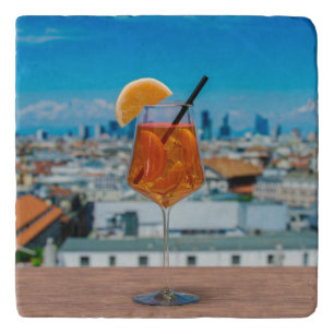 Spritz cocktail on a table with view of Milan Trivet