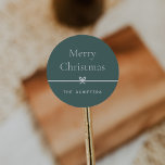 Spruce | Modern Bow Simple Minimal Christmas Classic Round Sticker<br><div class="desc">Finish your holiday mailings and gifts with these sweet and simple Christmas stickers,  customizable with your preferred holiday greeting and family signature (shown with "Merry Christmas") on a soft spruce green background. A petite bow running through the center completes this elegant minimalist holiday design.</div>