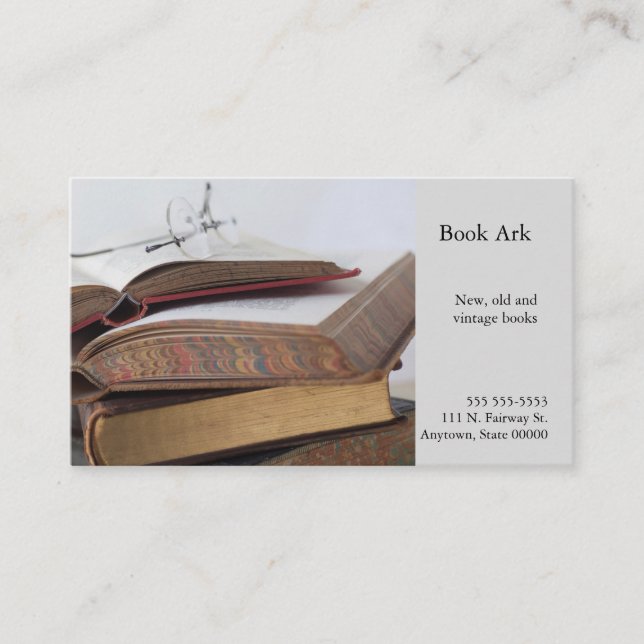 Stack of vintage books with glasses business card (Front)