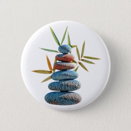 Stacked zen stones in balance with bamboo leaves  button