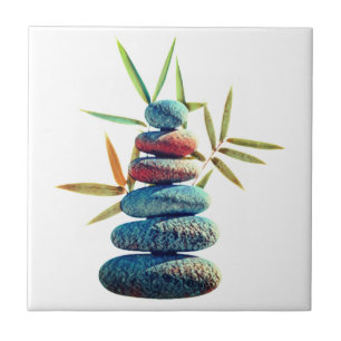 Stacked zen stones in balance with bamboo leaves.  ceramic tile