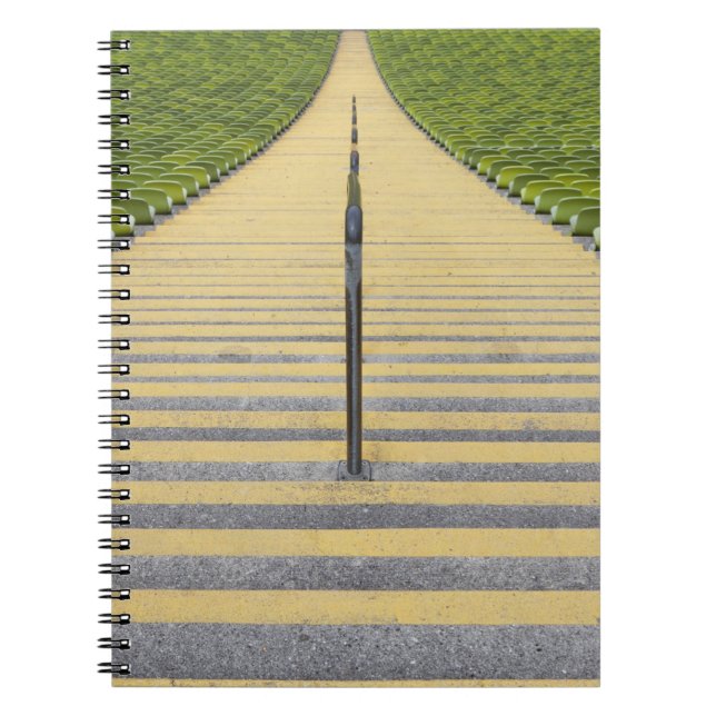 Stadium stairway between rows of green seats notebook (Front)