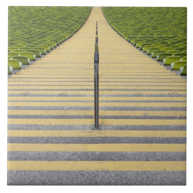 Stadium stairway between rows of green seats tile (Front)