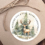 Stag and Christmas trees watercolor family name Classic Round Sticker<br><div class="desc">Labels featuring a beautiful watercolor painting of a stag standing in front of Christmas trees,  and a custom holiday greeting and your name. Default text "Wishing you a very merry Christmas".</div>