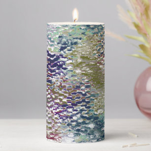 Stains and splatters of paint under hammered glass pillar candle