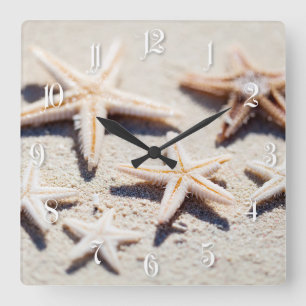 Starfish on sand square wall clock