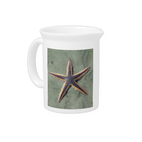 Starfish Purple sea star on beach Beverage Pitcher