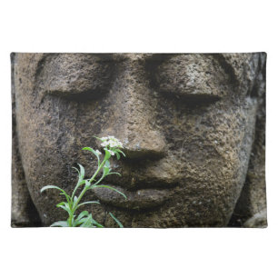 Stone garden statue with flower placemat