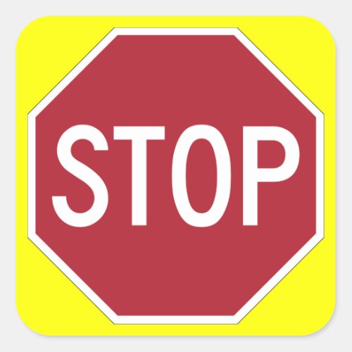 Stop sign on yellow square sticker