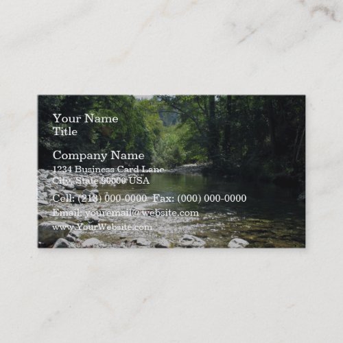 Stream flowing through trees business card