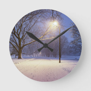 Street lights and covered in snow trees round clock