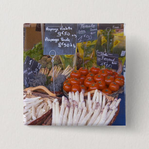 Street market merchant's stall with white pinback button