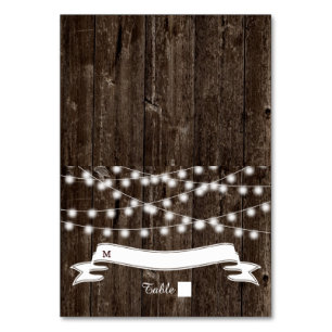 String of lights  on old wood wedding escort card