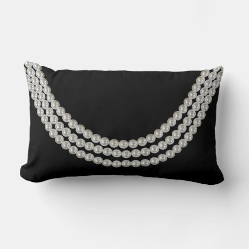 string of white pearls on black lumbar pillow