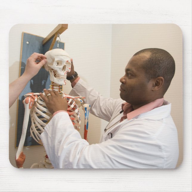 Student doctors studying anatomy on a skeleton mouse pad (Front)