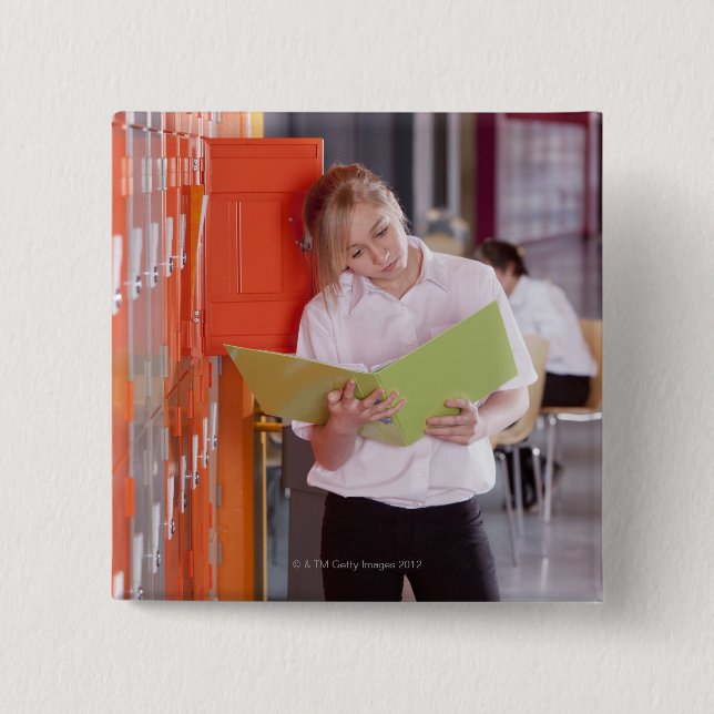 Student removing binder from school locker pinback button (Front)