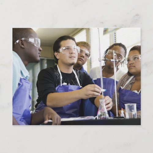 Students performing experiment in chemistry lab postcard