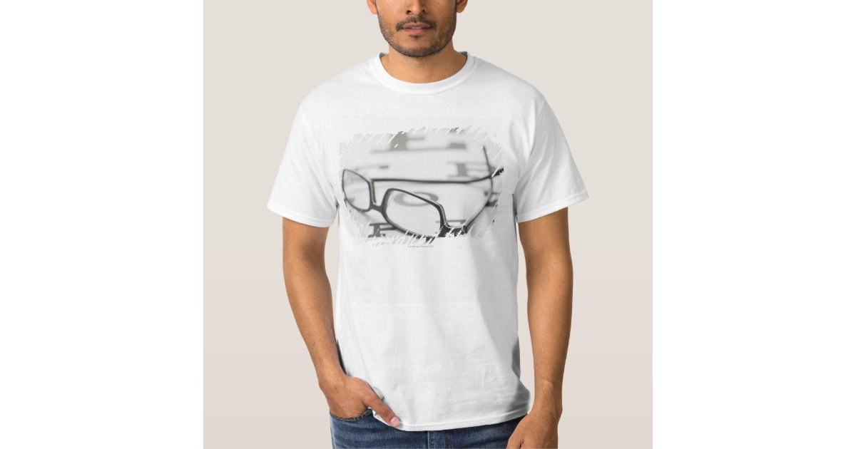 Studio shot of eyeglasses on eye chart TShirt