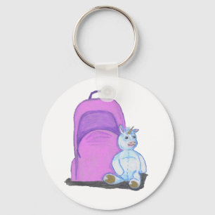 Stuffed Unicorn sits by a purple school Backpack Keychain