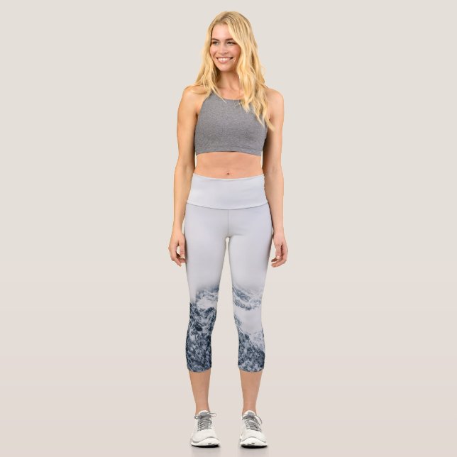 Stunning snowy mountains covered by clouds capri leggings (Front)
