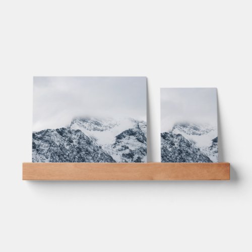 Stunning snowy mountains covered by clouds picture ledge