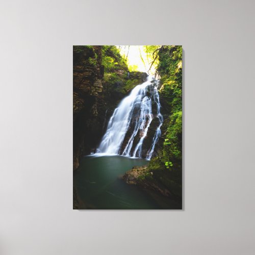Stunning waterfall with sunlight glow canvas print