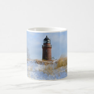 Sturdy Lighthouse on a Rocky Coast in Winter Coffee Mug