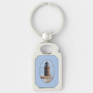 Sturdy Lighthouse on a Rocky Coast in Winter Keychain