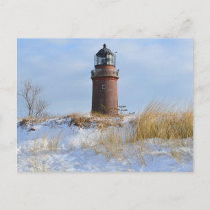 Sturdy Lighthouse on a Rocky Coast in Winter Postcard