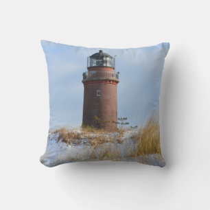 Sturdy Lighthouse on a Rocky Coast in Winter Throw Pillow