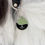 Stylish Black And Green Dog Paws Pattern & Name Pet ID Tag<br><div class="desc">This stylish black and green color design is split with a fun wave shape. On the bottom there is a curved personalizable text area for the name of the pet while on the top there is a pattern of white dog paw prints on a green background color. On the back...</div>