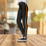 Stylish Black Leggings with Orange Side Stripe<br><div class="desc">These sleek and comfortable black leggings with a bold orange side stripe are the perfect addition to your casual wardrobe. Designed for both fitness and fashion, they offer a flattering fit and eye-catching style. Whether you're heading to the gym or running errands, these leggings provide the perfect blend of comfort...</div>