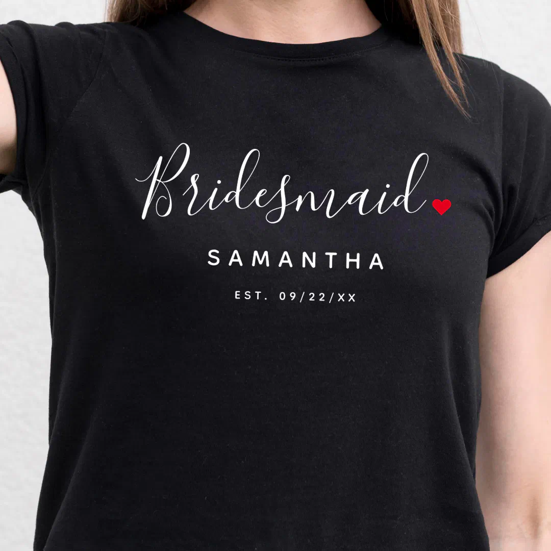 Zoomed in shot of a classic black t-shirt with white font text. There's a little red loveheart on the right side of the text.