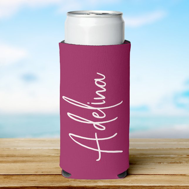 Stylish Script Custom Name Girls Beach Trip Seltzer Can Cooler (A maroon can cooler with a custom name  in elegant white script, set against a soft beach background)