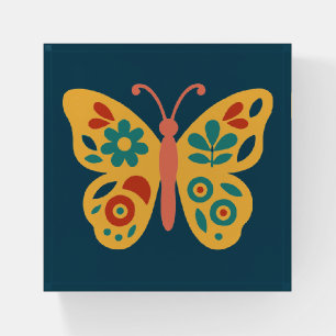 Stylized nature-inspired butterfly with floral paperweight
