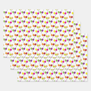 Suckers lollipops in green, purple, pink, yellow wrapping paper sheets