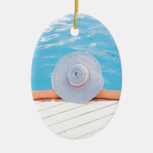 Summer time relaxing in pool nice hat ceramic ornament