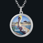 Sun Day Ocean Beach Pier Pelican Bird Photo Cute Silver Plated Necklace<br><div class="desc">“Sun day.” This cute, happy pelican perched on a railing overlooking a California beach screams “vacation ready”. Drift back to the warm ocean breezes whenever you wear this colorful photography charm necklace. This necklace comes in small, medium and large sizes, as well as both square and circle shapes. You can...</div>