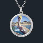 Sun Day Ocean Beach Pier Pelican Bird Photo Cute Silver Plated Necklace<br><div class="desc">“Sun day.” This cute, happy pelican perched on a railing overlooking a California beach screams “vacation ready”. Drift back to the warm ocean breezes whenever you wear this colorful photography charm necklace. This necklace comes in small, medium and large sizes, as well as both square and circle shapes. You can...</div>