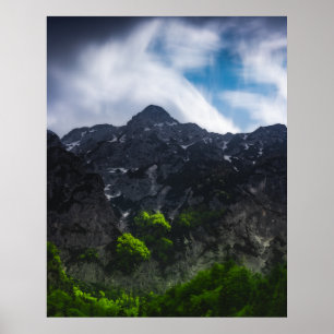 Sun lit green forest beneath the mountains poster