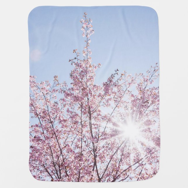 sun rays pass through pink flowers of a wow tree baby blanket (Front)