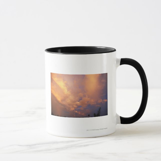 Sun setting behind clouds mug (Right)