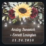 Sunflower and Burgundy Red Rose Rustic Wedding Square Sticker<br><div class="desc">Design features a barn wood grain background decorated with a floral element at the top that consists of watercolor garden eucalyptus,  greenery,  burgundy red roses and a sunflower. Design also features twinkle string lights with country rustic lighted mason jars.</div>