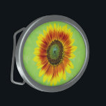 Sunflower Bold Floral Yellow and Green Flower Oval Belt Buckle<br><div class="desc">This cute summer floral design has a bold sunflower blossom in full bloom. It's made in shades of bright yellow, vivid orange and brown and green on a slightly distressed / grunge summery green background. The big flower has a painted look. If you love gardens and flowery motifs, you'll love...</div>