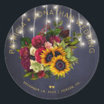 Sunflowers and burgundy roses rustic navy wedding classic round sticker<br><div class="desc">Editable text wedding favor sticker or envelope seal featuring a rustic big beautiful yellow sunflowers and red burgundy roses bouquet and faux gold typography script on a dark midnight navy blue background with string lights. Ideal for your winter, Christmas floral, late summer night or autumn fall | elegant rustic country...</div>