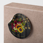 Sunflowers and burgundy roses rustic wood wedding classic round sticker<br><div class="desc">Editable text wedding favor sticker featuring a rustic big beautiful yellow sunflowers and red burgundy roses bouquet and faux gold typography script on a dark brown barn wood background with string lights. Ideal for your summer or autumn fall | elegant rustic country | outdoor backyard vintage traditional themed weddings. Personalize...</div>